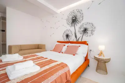 a white bathroom with a shower and a toilet at Primavera House in Faro