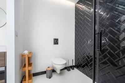 a bathroom with a toilet and a shower at Primavera House in Faro