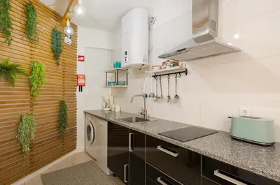 a kitchen with a sink and a washing machine at Studio 39 Downtown in Faro