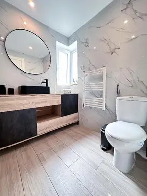 a bathroom with a toilet and a large mirror at Windmill Hill Gem Townhouse By BeCherish in Albufeira