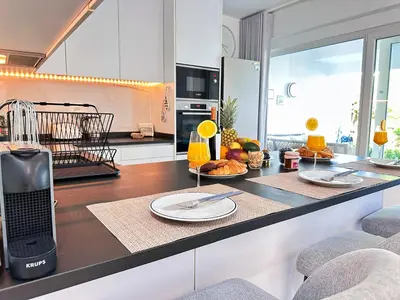 a kitchen with a counter with plates of food on it at Windmill Hill Gem Townhouse By BeCherish in Albufeira