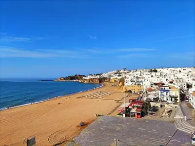 a view of a beach with buildings and the ocean at Windmill Hill Gem Townhouse By BeCherish in Albufeira
