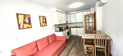 a living room with a red couch and a table at Ocean life in Albufeira