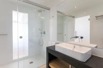 a white bathroom with a sink and a shower at Alfagar Prestige in Albufeira
