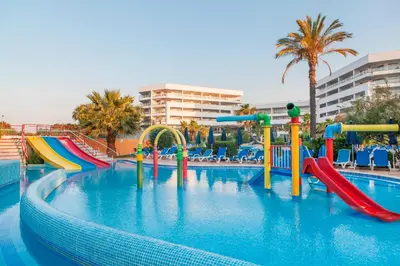 a swimming pool with a water slide in a resort at Alfagar Prestige in Albufeira