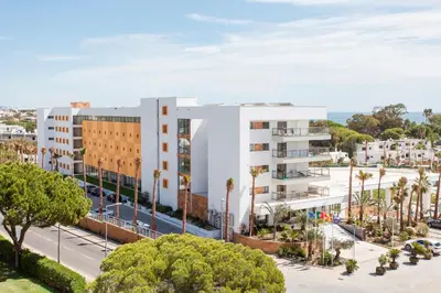 an aerial view of a white building with palm trees at Alfagar Prestige in Albufeira