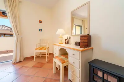 a bedroom with a dressing table and a mirror at 3 Quartos, Piscina, AC, Garagem, Prestige For Home in Faro