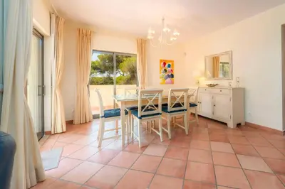a dining room with a table and chairs at 3 Quartos, Piscina, AC, Garagem, Prestige For Home in Faro