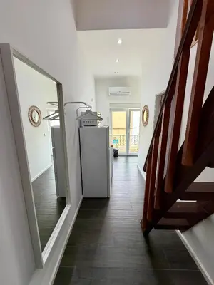 a hallway with a white refrigerator in a house at Albufeira Solmare Suites in Albufeira