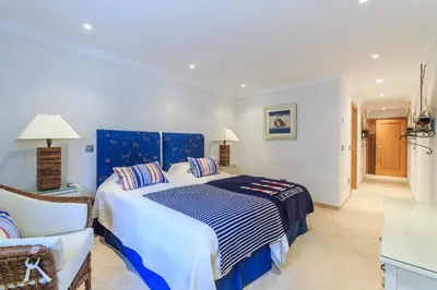 a bedroom with a blue and white bed and a chair at Villa Flow