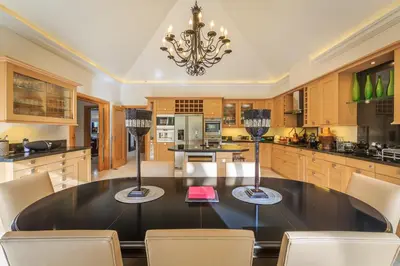 a large kitchen with a black table and chairs at Villa Flow
