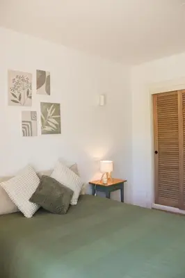 a bedroom with a large bed with a green blanket at Luxury Apartment in Vila Sol Resort in Quarteira