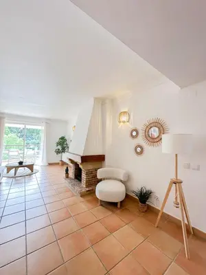 a living room with a fireplace and a chair at Luxury Apartment in Vila Sol Resort in Quarteira