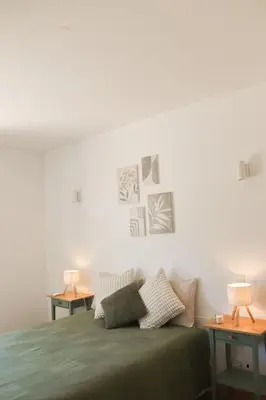 a bedroom with a green bed with two tables at Luxury Apartment in Vila Sol Resort in Quarteira