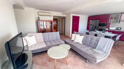 a living room with a couch and a table at Ocean View Quarteira in Quarteira