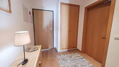 a room with a door and a table and a lamp at Jardins da Marina BQ in Albufeira