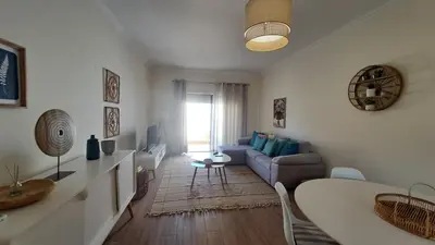 a living room with a couch and a table at Jardins da Marina BQ in Albufeira