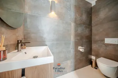 a white bedroom with a bed and a large window at Modern 4-Bedroom Villa with Infinity Pool in Albufeira