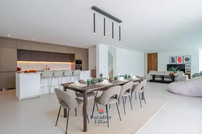 a white kitchen with a bowl of fruit on a counter at Modern 4-Bedroom Villa with Infinity Pool in Albufeira
