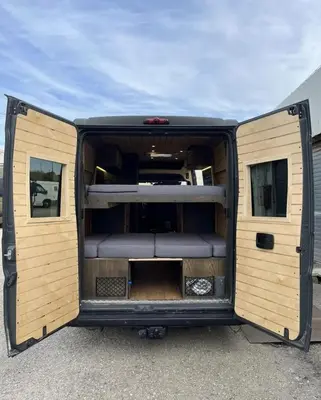 a large van with its doors open in a parking lot at Tiny House na Praia de Faro Experiencia Glamping in Faro