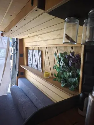 a shelf with a plant on it in a room at Tiny House na Praia de Faro Experiencia Glamping in Faro