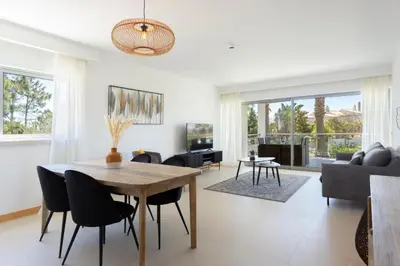 a living room with a wooden table and chairs at Snazzy Varandas do Castelo One Bedroom Apartment sleeps 2 persons in Albufeira