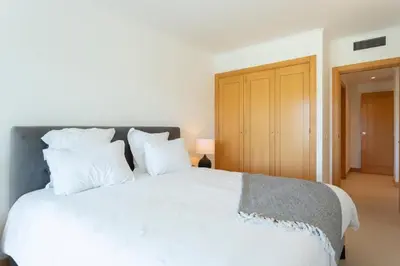 a bedroom with a large white bed with white pillows at Snazzy Varandas do Castelo One Bedroom Apartment sleeps 2 persons in Albufeira