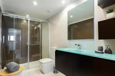 a bathroom with a shower and a toilet and a sink at Snazzy Varandas do Castelo One Bedroom Apartment with Sea View sleeps 2 in Albufeira