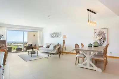 a living room with a table and a couch at Snazzy Varandas do Castelo One Bedroom Apartment with Sea View sleeps 2 in Albufeira