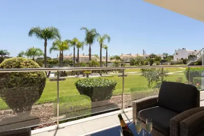a balcony with a view of a park with palm trees at Snazzy Varandas do Castelo - One Bedroom Apartment sleeps 2 person in Albufeira