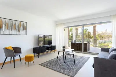 a living room with a couch and a table at Snazzy Varandas do Castelo One-Bedroom Apartment sleeps 2 person in Albufeira