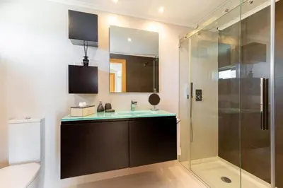a bathroom with a sink and a glass shower at Snazzy Varandas do Castelo One Bedroom Apartment with Sea View sleeps 2persons in Albufeira