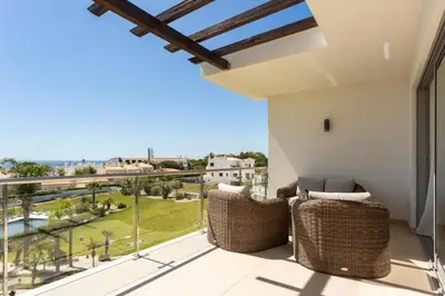 a balcony with wicker chairs and a view of the ocean at Snazzy Varandas do Castelo One Bedroom Apartment with Sea View sleeps 2persons in Albufeira