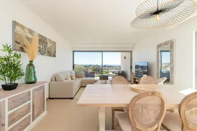 a living room with a dining room table and chairs at Snazzy Varandas do Castelo One Bedroom Apartment with Sea View sleeps 2persons in Albufeira