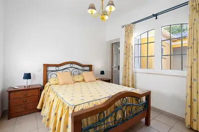 a bedroom with a bed and a mirror at Casa da Várzea in Albufeira