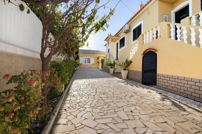 a cobblestone street in front of a house at Casa da Várzea in Albufeira