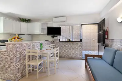 a kitchen and living room with a table and chairs at Casa da Várzea in Albufeira