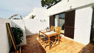 a small bedroom with a bed and two night stands at Villa With BBQ and Pool in Vilamoura in Quarteira