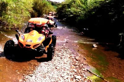 two people riding on a four wheeler in a river at Villa With BBQ and Pool in Vilamoura in Quarteira