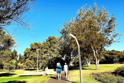 a man and a woman walking in a park at Villa With BBQ and Pool in Vilamoura in Quarteira