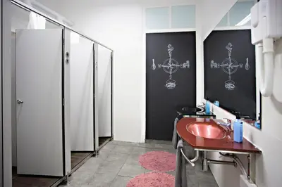 a bathroom with a red sink and a mirror at Baixa Terrace Hostel in Faro