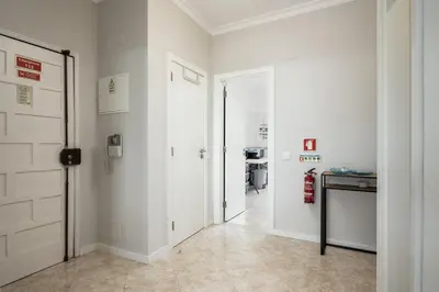 a hallway with white walls and a white door at Mar e Golfe - Pool with golf view by HD in Vilamoura