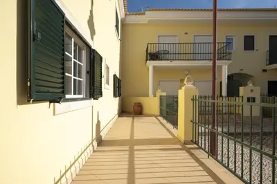 a hallway leading to a house with a fence at Mar e Golfe - Pool with golf view by HD in Vilamoura