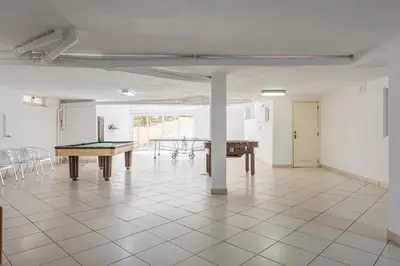 a room with a ping pong table and chairs at Vila Popa - Golf Front with Games Room by HD in Vilamoura