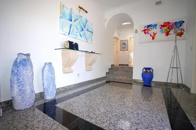 a room with three blue vases on a wall at Vila Luz in Vilamoura