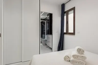 a bedroom with a mirror and a bed with towels at Marina Praia - Marina view by HD in Vilamoura