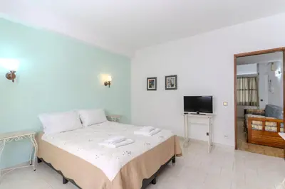 a kitchen with wooden cabinets and a wooden table with a tableablish at #352 Travessa do Mar Flats by Home Holidays in Albufeira