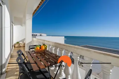two beds in a room with a view of the ocean at #352 Travessa do Mar Flats by Home Holidays in Albufeira