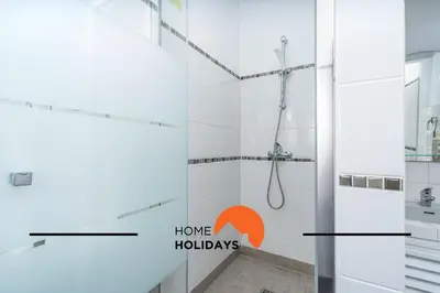 a bedroom with a bed and a chair and a window at #352 Travessa do Mar Flats by Home Holidays in Albufeira