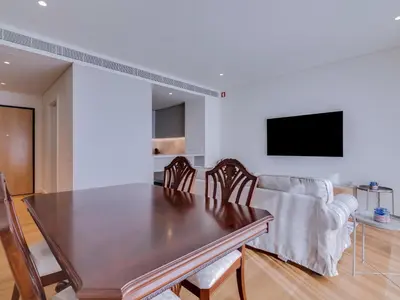 a dining room with a table and a couch at 2bdr Horizon Sand apartment in Quarteira in Quarteira